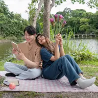 Picnic date./Copyright depositphotos.com/photo/cheerful-couple-sitting-back-back-picnic-blanket-lake-reading-enjoying-733393746.html