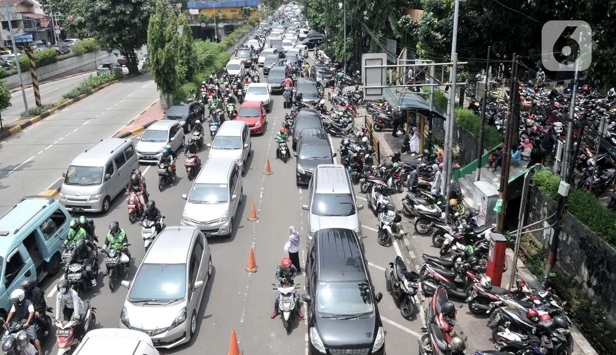Kendaraan terjebak kemacetan di depan Pasar Pramuka, Jakarta, Senin (16/3/2020). Pasar Pramuka diserbu pembeli yang mencari masker guna mengantisipasi virus Corona Covid-19, membuat sebagian badan jalan dimanfaatkan sebagai parkiran sehingga menyebabkan kemacetan panjang. (merdeka.com/Iqbal Nugroho)