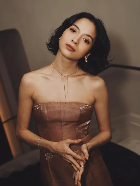Sebuah strapless form dress berwarna emas ini memiliki detail manis berupa high slit, yang memamerkan kaki jenjang nan indah milik Putri Marino. [Foto: Instagram/putrimarino]