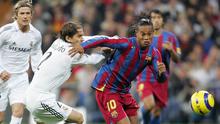 Ronaldinho mengelabui Michel Salgado dalam laga El Clasico di Stadion Santiago Bernabeu, Madrid, (19/11/2005). Ronaldinho mencetak dua dari tiga gol kemenangan Barcelona. (AFP Photo/Javier Soriano)