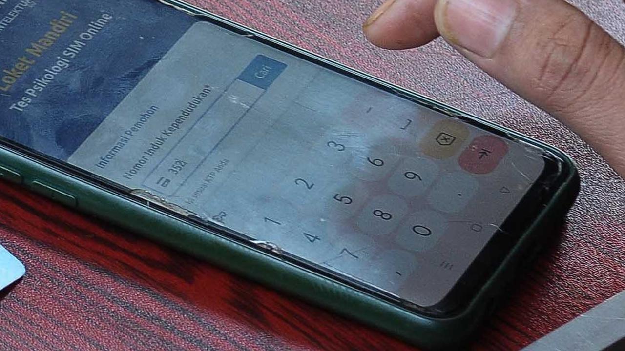 Pemohon perpanjangan SIM mencoba melakukan pendaftaraan secara Online di Gerai Satpas Jakarta Timur untuk mengikuti tes Psikologi.