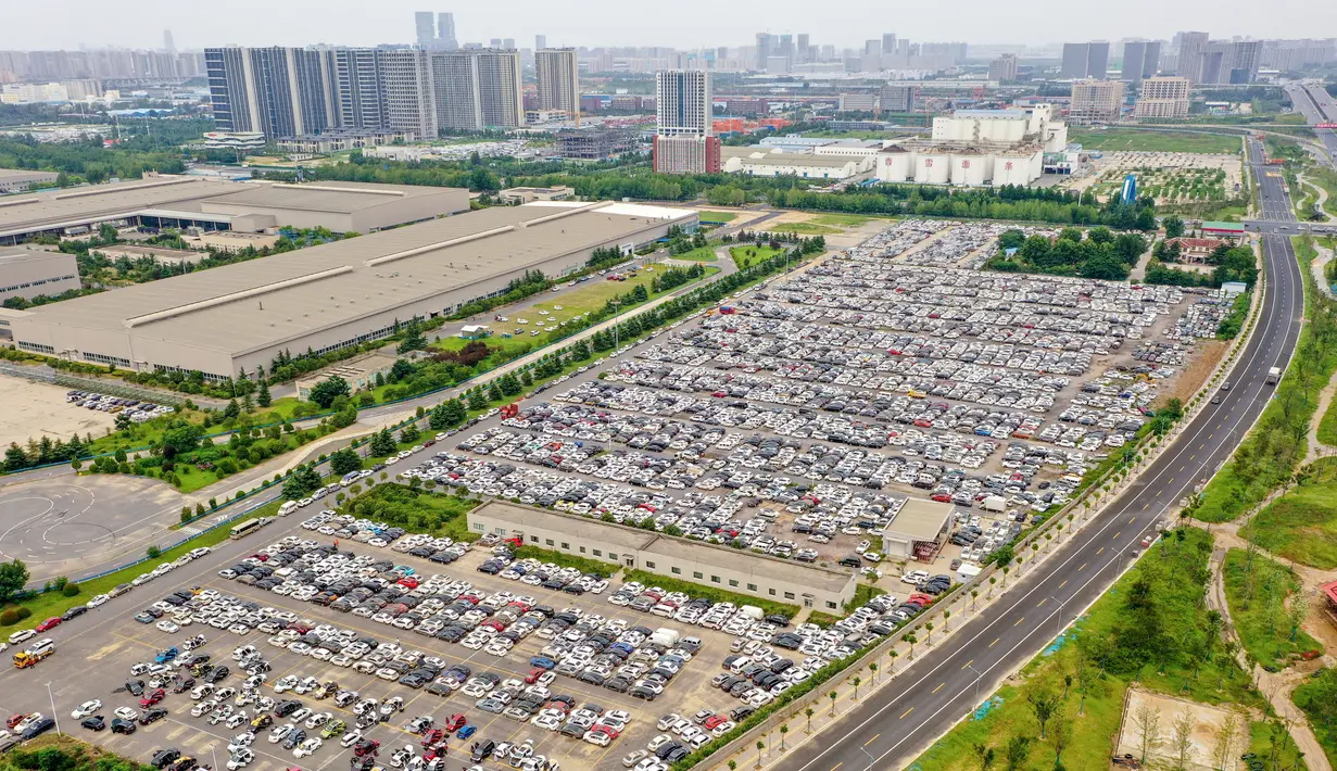 Foto udara yang diambil pada 10 Agustus 2021 ini menunjukkan kendaraan yang rusak akibat banjir pada Juli di tempat parkir, beberapa di antaranya akan dibuang, di Zhengzhou di provinsi Henan, China. Ada lebih dari 4.000 mobil yang terendam diparkir, termasuk Tesla Model 3 dan Audi. (STR / AFP)