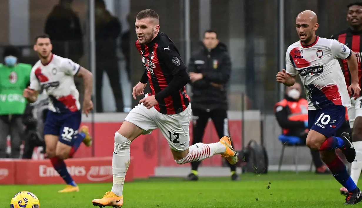 Striker AC Milan, Ante Rebic (kiri) dan gelandang Crotone, Ahmed Benali berlari mengejar bola dalam laga lanjutan Liga Italia 2020/21 pekan ke-21 di San Siro Stadium, Milan, Minggu (7/2/2021). AC Milan menang 4-0 atas Crotone. (AFP/Miguel Medina)
