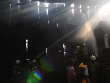 Petugas pemadam kebakaran masih melakukan proses "pendinginan" di lokasi kebakaran sebuah gudang tripleks di Jalan Cipinang Muara Dua, Jakarta Timur terbakar, Rabu (31/5/2023). (merdeka.com/Imam Buhori)