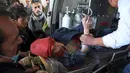 Tim medis dibantu warga memberikan pertolongan kepada wanita korban serangan bom bunuh diri di Kabul, Afghanistan (28/12). Ledakan tersebut menewaskan puluhan orang. Dilaporkan bahwa kebanyakan korban ledakan adalah pelajar. (AP Photo / Rahmat Gul)
