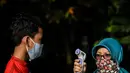 Seorang anak diukur suhu tubuh sebelum latihan memanah yang diadakan SAN Archery Club di Desa Ciater, Tangerang Selatan (9/8/2020). SAN Archery Club dibuka kembali bagi anggotanya untuk berlatih kembali dengan mengikuti protokol kesehatan di tengah wabah COVID-19. (Agung Kuncahya B./Xinhua)