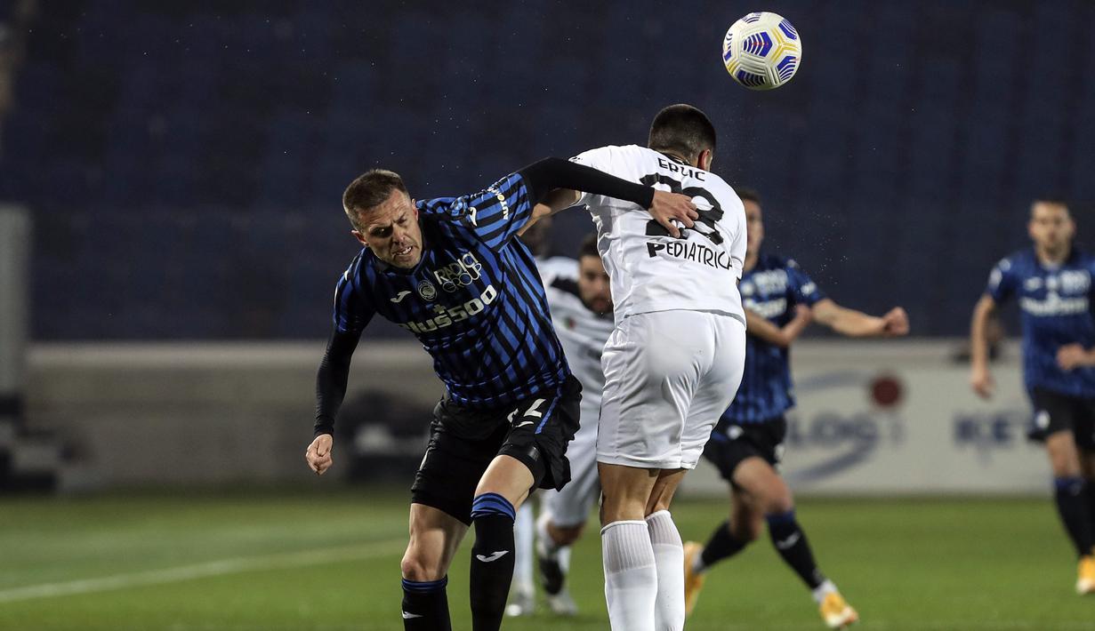 Gelandang Atalanta, Josip Ilicic (kiri) berebut bola dengan bek Spezia, Martin Erlic dalam laga lanjutan Liga Italia 2020/2021 pekan ke-27 di Gewiss Stadium, Bergamo, Jumat (12/3/2021). Atalanta menang 3-1 atas Spezia. (LaPresse via AP/Stefano Nicoli)