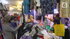 Calon pembeli memilih pakaian bekas di salah satu kios Pasar Senen Blok III, Jakarta, Kamis (11/6/2020). Pasar yang tetap buka saat PSBB dengan pembatasan jam operasional ini akan kembali dibuka secara normal pada 15 Juni 2020 dengan aturan protokol kesehatan COVID-19. (Liputan6.com/Herman Zakharia)