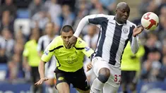 West Bromwich Albion's striker Marc-Antoine Fortune runs away from Wigan's Paul Sharner during English Premier League match between WBA and Wigan at The Hawthorns, on May 9th, 2009. AFP PHOTO/Olly Greenwood
