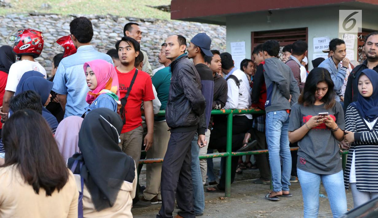 Sejumlah suporter antri di loket tiket laga semifinal Kejuaraan Voli Asia 2017 di di GOR Tri Dharma, Gresik, Senin (31/7). Tiket laga semifinal semifinal Kejuaraan Voli Asia 2017 terjual habis. (Liputan6.com/Helmi Fithriansyah)