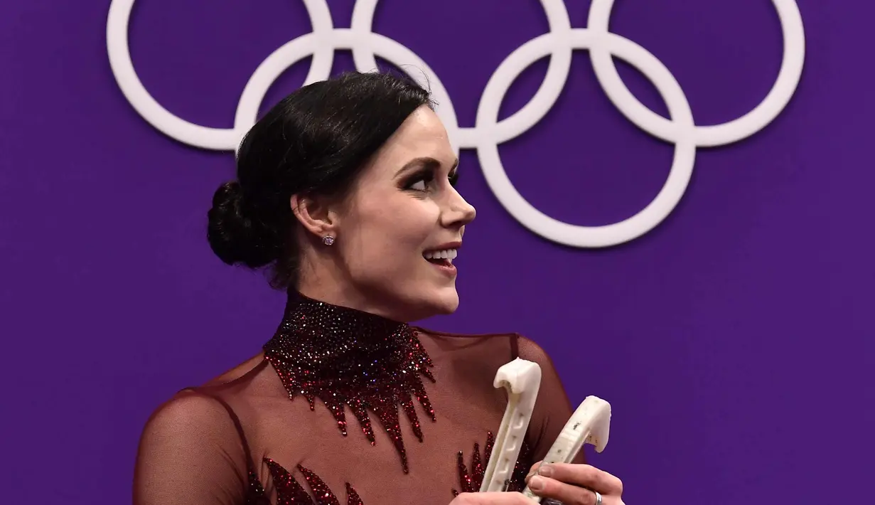 Tessa Villeue tersenyum setelah meraih emas pada Olimpiade Musim Dingin Pyeongchang 2018 di Gangneung Ice Arena (20/2). Atlet 28 tahun ini bersama rekannya Scott Moir meraih emas pada Olimpiade Musim Dingin Pyeongchang 2018. (AFP Photo/Aris Messinis)