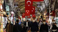 Sejumlah pengunjung menggenakan masker saat berjalan-jalan di Grand Bazaar yang dibuka kembali setelah ditutup karena COVID-19 di Istanbul, Turki, (1/6/2020). (AP Photo/Emrah Gurel)