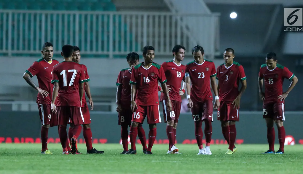 Pemain Timnas Indonesia U-23 berjalan tertunduk usai bermain imbang melawan Thailand U-23 pada laga persahabatan di Stadion Pakansari, Kab Bogor, Minggu (3/6). Laga berakhir imbang 0-0. (Liputan6.com/Helmi Fithriansyah)