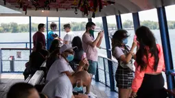 Para penumpang yang mengenakan masker terlihat di sebuah kapal feri di Toronto, Kanada (27/6/2020). Layanan kapal feri menuju Kepulauan Toronto kembali dibuka untuk umum mulai Sabtu (27/6), dengan mewajibkan penumpang memakai masker atau pelindung wajah. (Xinhua/Zou Zheng)