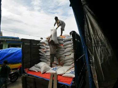 Pekerja menurunkan karung beras di pasar induk Cipinang, Jakarta, Selasa (27/12). Menteri Perdagangan (Mendag) Enggartiasto Lukita mengatakan, stok kebutuhan pokok pangan hingga akhir tahun akan cukup. (Liputan6.com/Angga Yuniar)