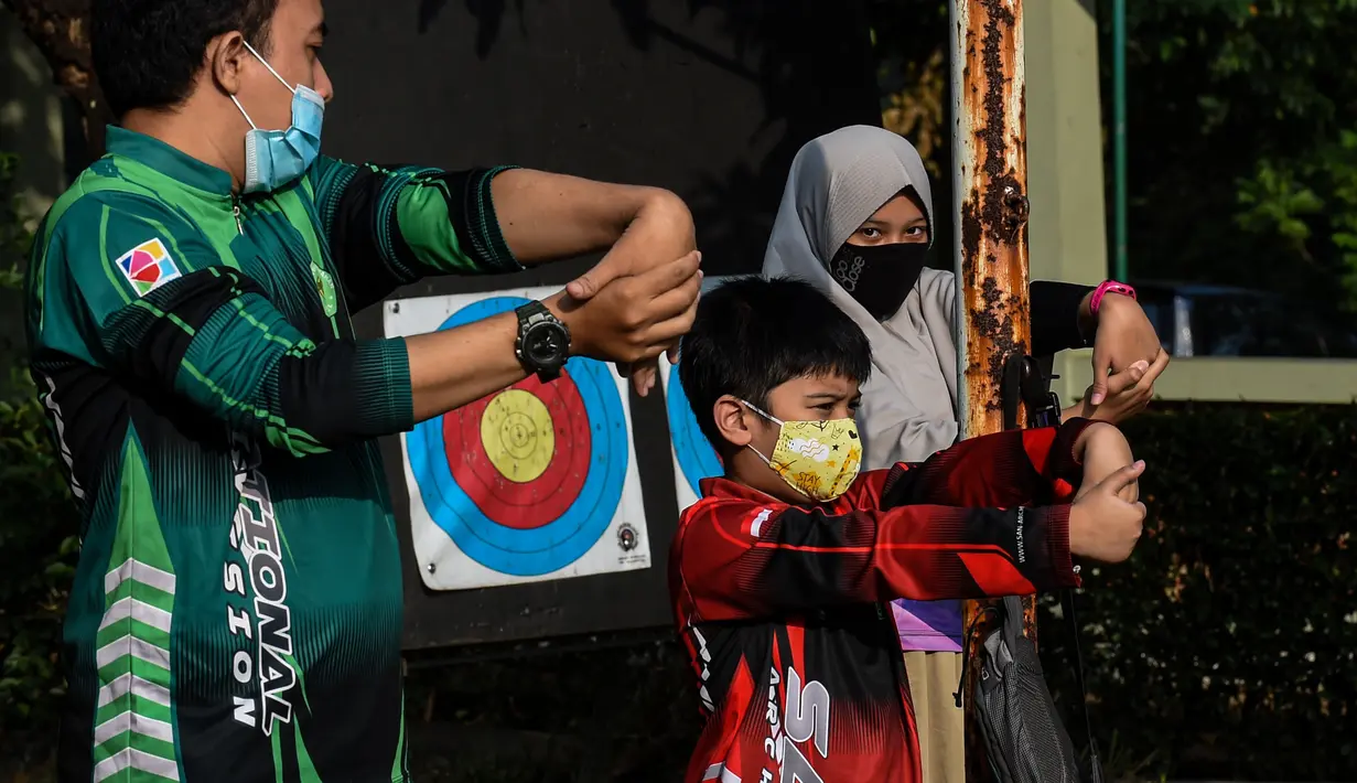 Anak-anak melakukan pemanasan saat mengikuti latihan memanah yang diadakan SAN Archery Club di Desa Ciater, Tangerang Selatan (9/8/2020). SAN Archery Club dibuka kembali bagi anggotanya untuk berlatih kembali dengan mengikuti protokol kesehatan di tengah wabah COVID-19. (Agung Kuncahya B./Xinhua)