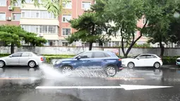 Mobil menerjang genangan usai hujan deras akibat Topan Haishen di Changchun, Provinsi Jilin, China, 8 September 2020. Kantor Pusat Pengendalian Banjir dan Bantuan Kekeringan Negara China menaikkan status tanggap darurat pengendalian banjir dan topan dari Level IV ke Level III. (Xinhua/Yan Linyun)