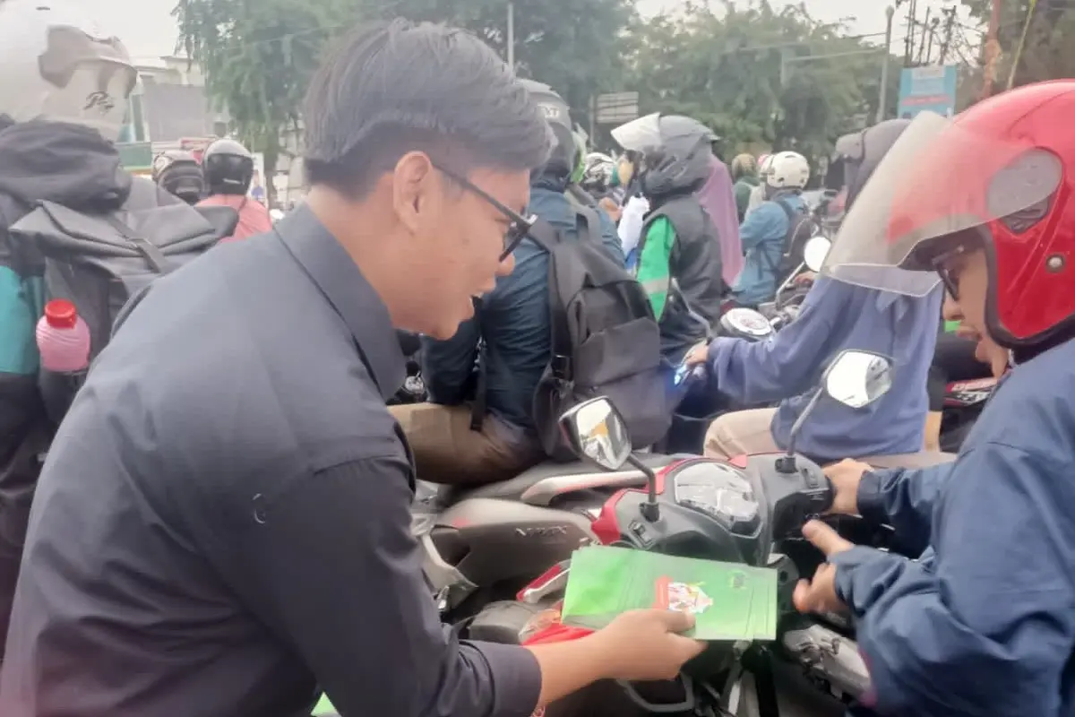 Aktivis Jaringan Muda Indonesia Rahmat Hidayat pada acara bagi-bagi striker bertuliskan menolak hoaks, politik SARA dan fitnah di Jakarta. (Istimewa)