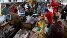 Pembeli antre menunggu untuk membayar belanjaan mereka di supermarket yang dikelola pemerintah Pakistan di Islamabad, Rabu (16/5). Warga berbelanja untuk berbagai persiapan Puasa Ramadan yang dimulai pada Kamis (17/5). (AP/Anjum Naveed)