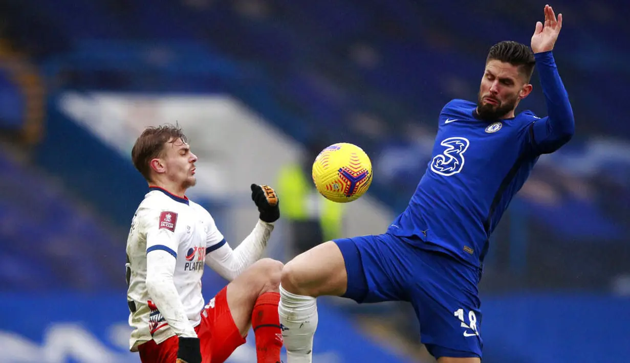 Striker Chelsea, Olivier Giroud, berebut bola dengan pemain Luton Town, Kiernan Dewsbury, pada laga Piala FA di Stadion Stamford Bridge, Minggu (24/1/2021). Chelsea menang dengan skor 3-1. (AP/Ian Walton)