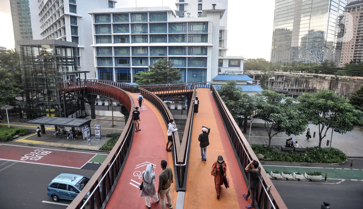 Warga ngabuburit di JPO Pinisi Pinisi Karet-Sudirman, Jakarta Pusat, Senin (4/4/2022). JPO Pinisi kini menjadi destinasi baru warga Jakarta untuk menunggu waktu berbuka puasa atau ngabuburit sambil menikmati suasana perkotaan. (merdeka.com/Iqbal S. Nugroho)