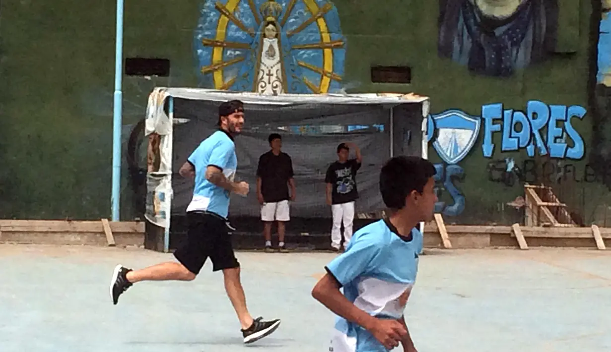 Bintang Sepak Bola David Beckham bermain bola bersama anak-anak untuk pembuatan film Dokumenter di Buenos Aires, Senin (9/11/2015).  (AFP Photo/FIXER-ARGENTINA/Macarena Galiardi)