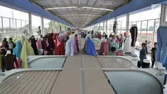 Pengunjung melintasi sejumlah kios pedagang di Skybridge atau jembatan multiguna Tanah Abang, Jakarta, Selasa (11/12). Ini merupakan hari keempat uji coba Skybridge Tanah Abang. (Merdeka.com/Iqbal Nugroho)