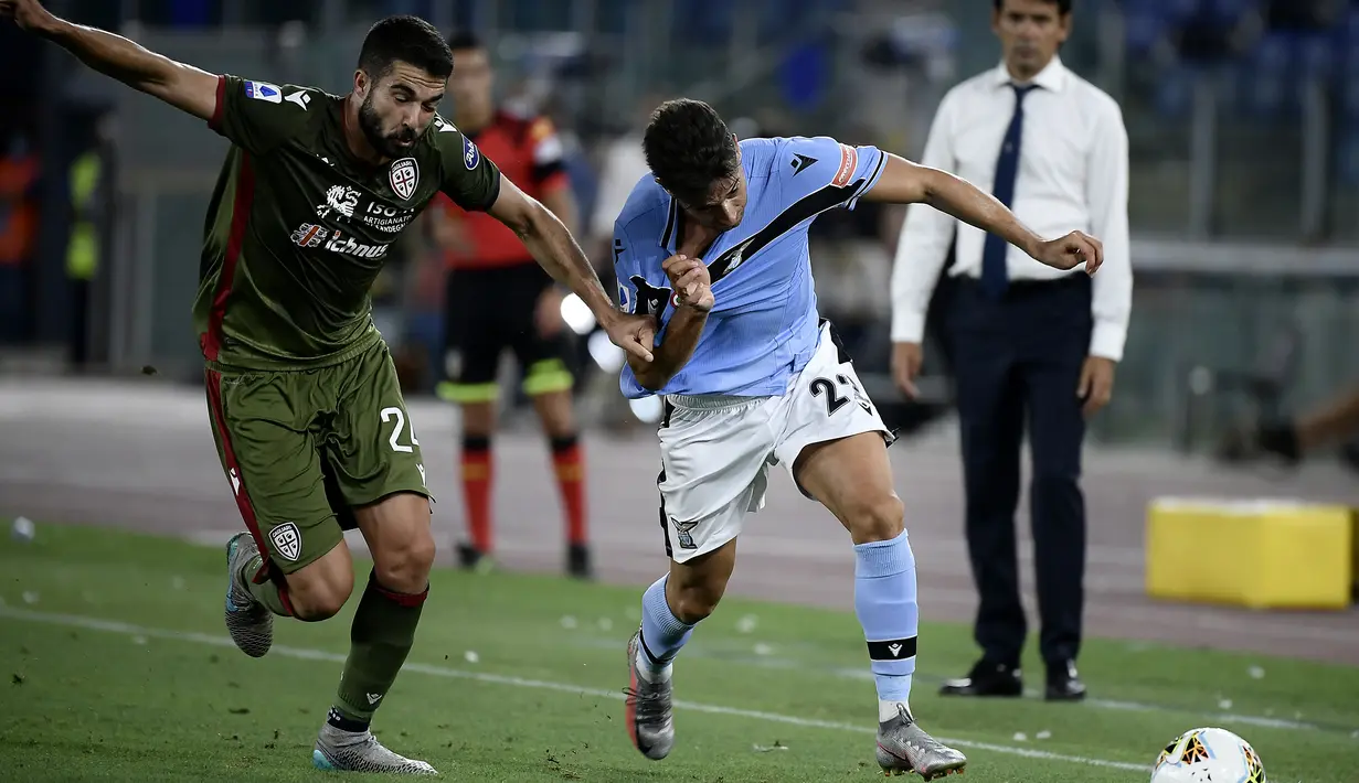 Penyerang Lazio, Jony Rodriguez, berebut bola dengan gelandang Cagliari, Paolo Farago, pada laga lanjutan Serie A pekan ke-35 di Stadio Olimpico, Jumat (24/7/2020) dini hari WIB. Lazio menang 2-1 atas Cagliari.(AFP/Filippo Monteforte)