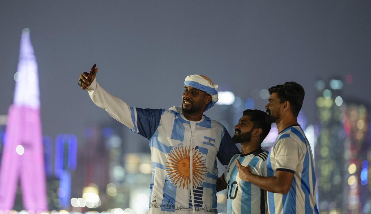 Fans Argentina berswafoto di corniche Doha, di Doha, Qatar, Senin, 12 Desember 2022. Argentina akan menghadapi Kroasia dalam pertandingan semifinal Piala Dunia 2022 di Stadion Lusail Iconic Qatar, Rabu (14/12/2022) mulai pukul 02.00 WIB. (AP Photo/Andre Penner)