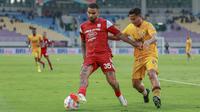 Striker asing Persis Solo, Jhon Cley, saat melindungi bola dari bek Semen Padang, Zidane Pramudya Afandi, dalam duel yang berlangsung di Stadion Manahan, Solo, Jumat (21/2/2025). (Bola.com/Radifa Arsa)