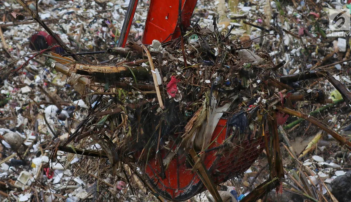 Alat berat (becko) beroperasi mengangkut sampah yang menumpuk di Pintu Air Manggarai, Jakarta, Rabu (24/4). Tingginya curah hujan di Bogor membuat sampah yang berasal kebanyakan dari sampah rumah tangga ini terbawa arus sungai menumpuk di Pintu Air Manggarai. (Liputan6.com/Johan Tallo)