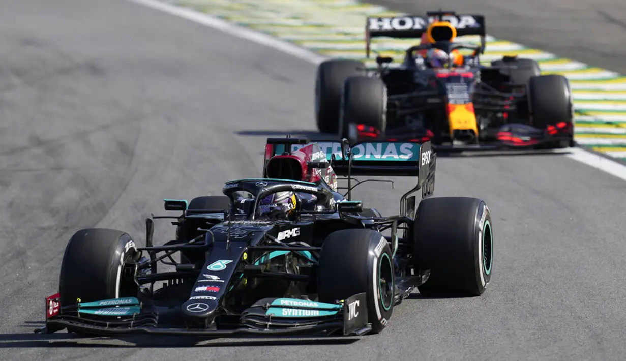 Pembalap Mercedes Lewis Hamilton (depan) mengemudikan mobilnya diikuti pembalap Red Bull Max Verstappen pada Formula 1 Grand Prix di Sirkuit Interlagos, Sao Paulo, Brasil, 14 November 2021. Lewis Hamilton di urutan pertama, Max Verstappen kedua, dan Valtteri Bottas ketiga. (AP Photo/Andre Penner)