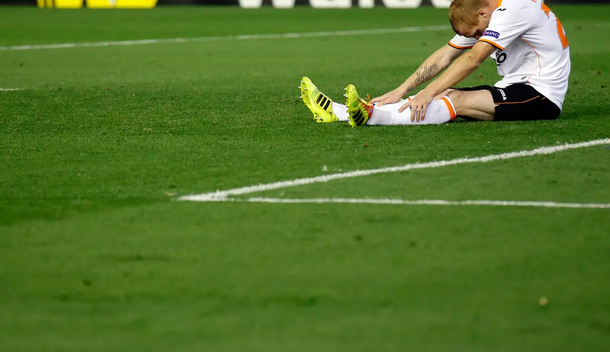 Bek kiri Valencia, Jeremy Mathieu tertunduk lesu usai gagal membawa timnya masuk ke fase final Liga Europa 2014 di Stadion Mestalla, Valencia (2/5/2014). (REUTERS/Albert Gea)