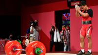 Eko Yuli berusaha di angkatan kedua clean and jerk, namun beban 172 kg masih terlalu berat untuk Eko. Kesempatan terakhir lifter berumur 31 tahun ini juga tak menemui hasil dan harus puas dengan urutan kedua. (Foto: AFP/Vincenzo Pinto)