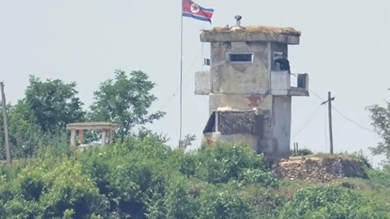 Tentara berjaga di pos militer Korea Utara dengan bendera berkibar, tampak dari Paju, Korea Selatan, 26 Juni 2024.