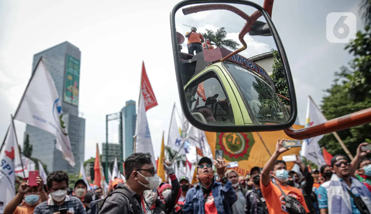Buruh yang tergabung dalam Konfederasi Serikat Pekerja Indonesia berunjuk rasa di depan Kantor Kementerian Ketenagakerjaan, Jakarta, Rabu (16/2/2022). Buruh menuntut Permenaker Nomor 2 Tahun 2022 yang mengatur JHT baru bisa dicairkan pada usia 56 tahun segera dicabut. (Liputan6.com/Faizal Fanani)