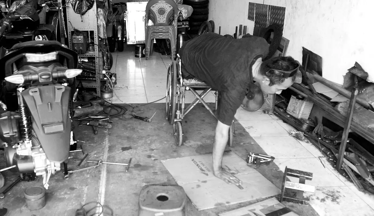 Penyandang disabilitas Catur Bambang (45) menyelesaikan pembuatan sepeda motor roda tiga di bengkelnya, Jalan Wijaya Kusuma, Ciputat Timur, Tangerang Selatan, Banten, Selasa (5/11/2019). Harga pembuatan sepeda motor roda tiga berkisar Rp 6 juta - Rp 15 juta per unit. (merdeka.com/Arie Basuki)