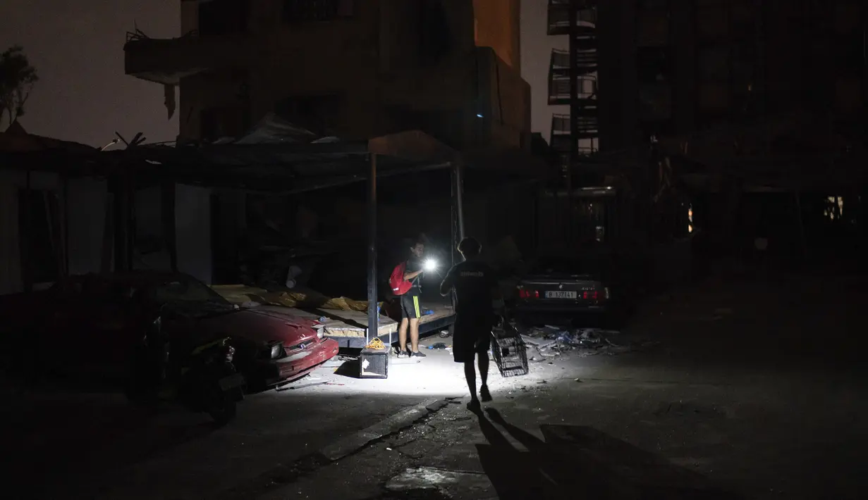 Relawan Animals Lebanon Kamal Khatib membawa perangkap untuk menyelamatkan kucing yang bersembunyi di antara puing bangunan dekat lokasi ledakan besar, Beirut, Lebanon, Kamis (13/8/2020). Animals Lebanon dikerahkan untuk menyelamatkan hewan peliharaan. (AP Photo/Felipe Dana)