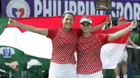 Petenis ganda putri Indonesia, Beatrice Gumulya dan Jessy Rompies, merayakan kemenangan di final SEA Games 2019 di Rizal Memorial Tennis Court, Sabtu (7/12/2019). (Bola.com/Muhammad Iqbal Ichsan)