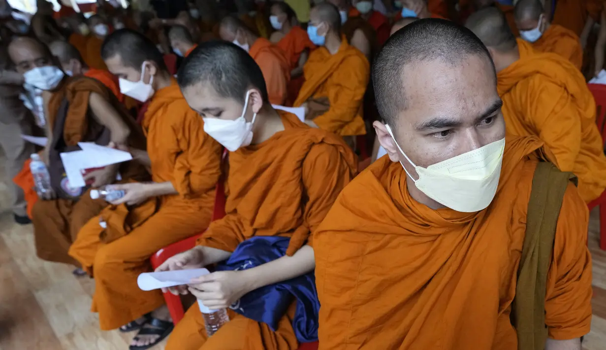 Para biksu menunggu kemungkinan efek samping setelah menerima vaksin AstraZeneca COVID-19 di Wat Srisudaram di Bangkok, Thailand (30/7/2021). Para biksu tersebut mendapatkan dosis vaksin AstraZeneca COVID-19. (AP Photo/Sakchai Lalit)