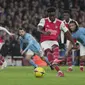 Gelandang Arsenal, Bukayo Saka menembak untuk mencetak gol dari titik penalti ke gawang Manchester City selama pertandingan lanjutan Liga Inggris di stadion Emirates di London, Inggris, Kamis (16/2/2023). Hasil ini membuat Man City menggeser Arsenal di puncak klasemen. (AP Photo/Kin Cheung )