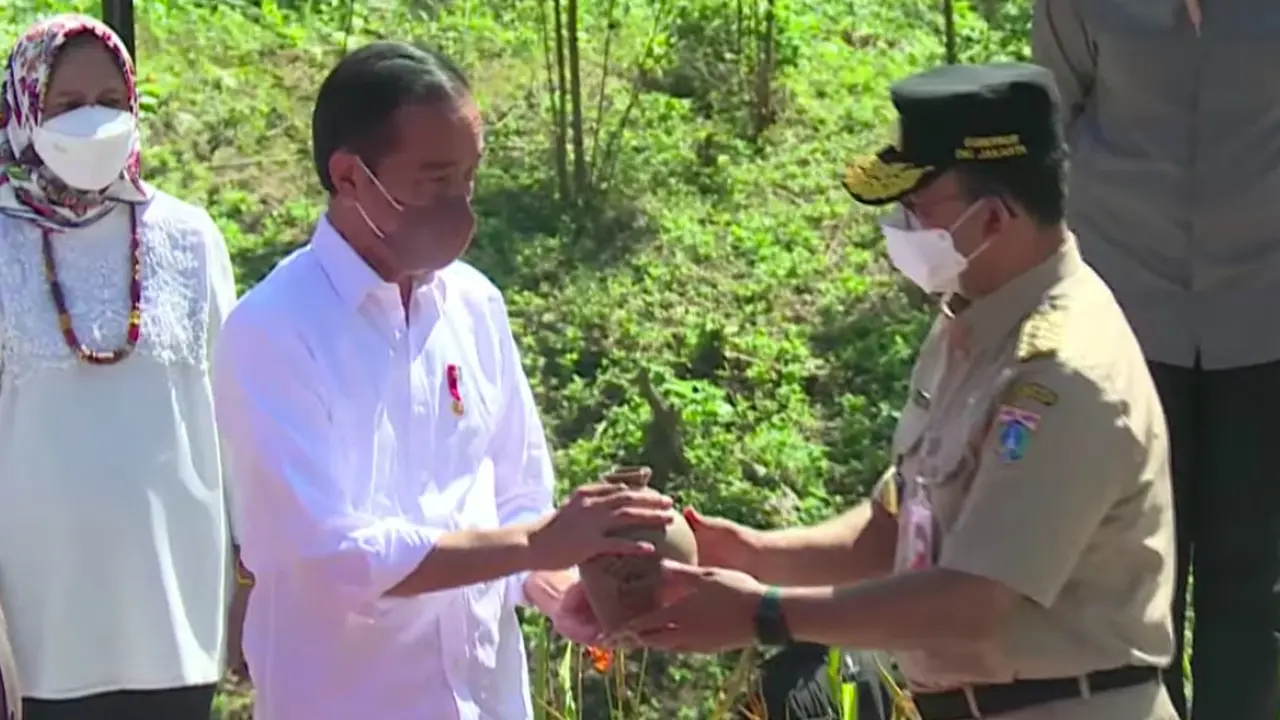 Gubernur Anies Baswedan menyerahkan kendi berisi air yang diambil dari kawasan Jakarta Utara di kilometer 0 IKN Nusantara kepada Presiden Jokowi.