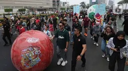 Masryarakat bersama sejumlah artis dan influencer ditambah khalayak umum ikut meramaikan parade bola raksasa dari kawasan Sarinah menuju Bundaran HI, lokasi piala dipamerkan. (Liputan6.com/Faizal Fanani)