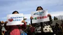 Anggota keluarga penumpang pesawat Malaysia Airlines MH370 berunjuk rasa membawa poster di Lama Temple, Beijing, Cina, (8/3). Poster Tersebut bertuliskan "Ibu akan selalu menunggu. Tidak akan menyerah." (REUTERS/Kim Kyung-hoon)