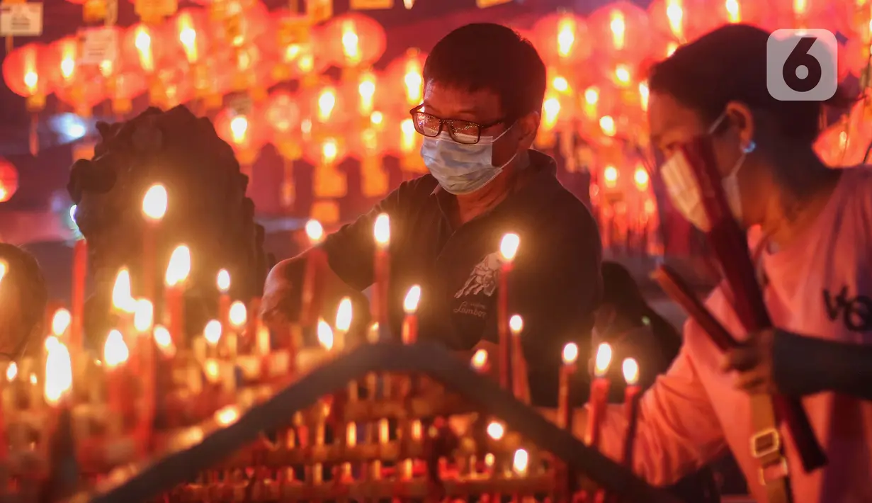 Warga keturunan Tionghoa membakar dupa saat melaksanakan sembahyang malam Imlek 2574 di Wihara Boen San Bio, Kota Tangerang, Banten, Sabtu (21/1/2023). Sembahyang malam pergantian tahun baru Imlek itu sebagai ungkapan syukur atas segala rezeki dan keselamatan dari Tuhan serta untuk pengharapan kehidupan lebih baik di tahun Kelinci Air mendatang. (Liputan6.com/Angga Yuniar)