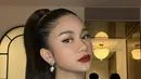 Disempurnakan dengan pulasan makeup bold karya MUA @ochiipramita, yang berfokus pada aplikasi lipstik nuansa bold maroon pada bibirnya. Sementara rambutnya ditata bergaya ponytail. [@ochiipramita/@azizahsalsha_]