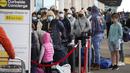 Penumpang antre untuk memeriksa bagasi mereka di tepi jalan terminal Bandara Internasional Denver di Denver, AS, Senin (3/1/2022). Badai musim dingin ditambah pandemi membuat frustrasi pelancong yang penerbangan pulang dari liburannya dibatalkan atau ditunda di awal tahun (AP Photo/David Zalubowski)