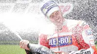Pembalap Ducati, Andrea Dovizioso menyemprotkan sampanye setelah memenangi MotoGP Catalunya di sirkuit Barcelona Catalunya, Minggu (11/6). Dovizioso menyelesaikan balapan dengan catatan waktu tercepat 44 menit 41,518 detik. (AP Photo/Manu Fernandez)