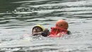 Anggota tim penyelamat berusaha menyelamatkan korban yang tenggelam pada lomba ketangkasan water rescue di Kanal Banjir Timur, Jakarta, Kamis (3/5). Perlombaan guna melatih kemampuan melakukan penyelamatan dan pertolongan di air. (Merdeka.com/Imam Buhori)