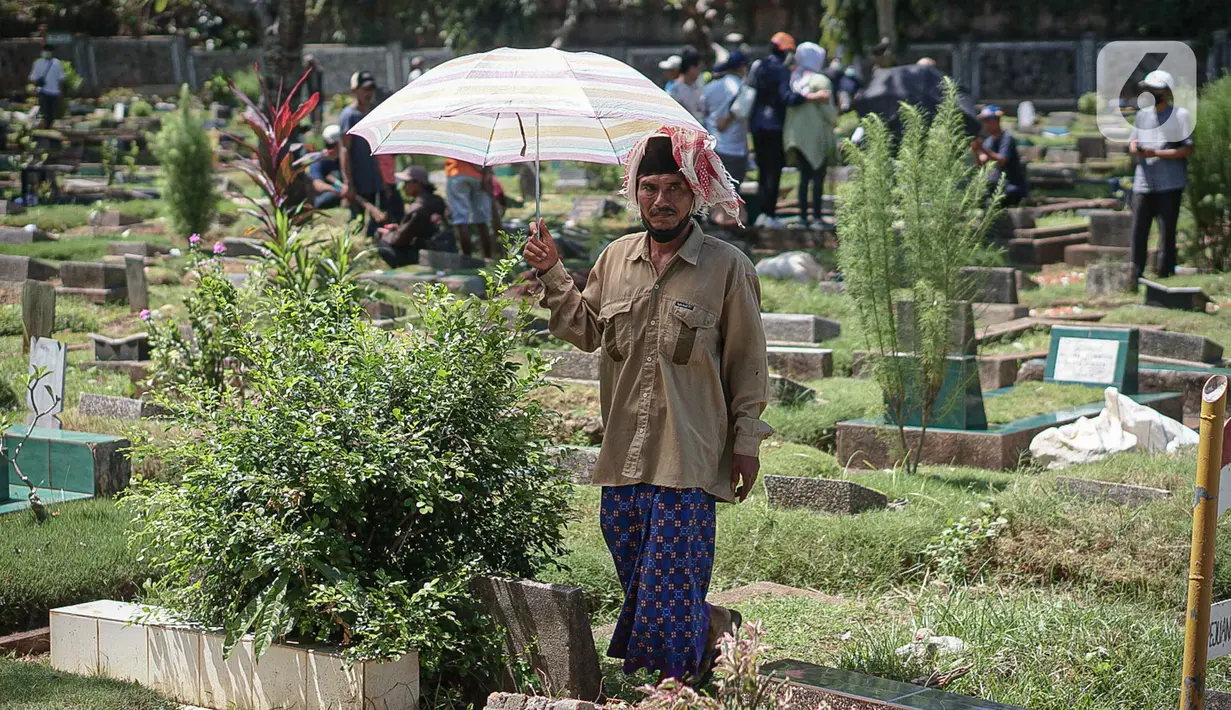Seorang pria muslim berjalan di Tempat Pemakaman Umum (TPU) Karet Tengsin, Jakarta, Minggu (27/3/2022). Sepekan jelang datangnya bulan suci Ramadan, banyak warga yang melakukan tradisi ziarah makam untuk mendoakan keluarganya. (Liputan6.com/Faizal Fanani)